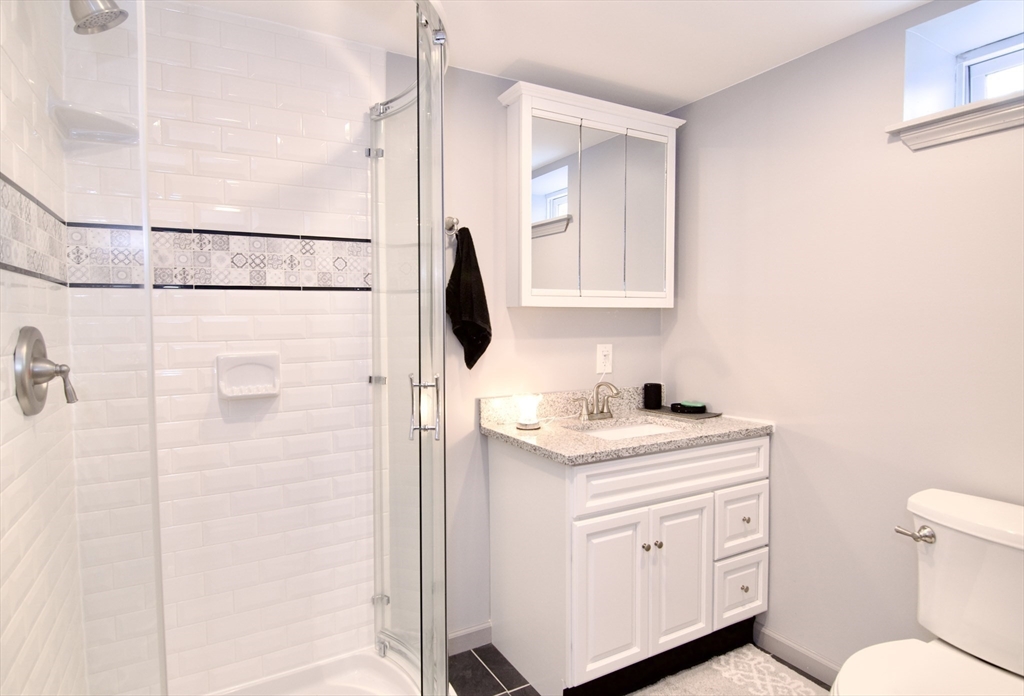 75 Wilton Street Springfield, MA 01109 - Photo 40 of 42 a bathroom with a granite countertop sink toilet and shower