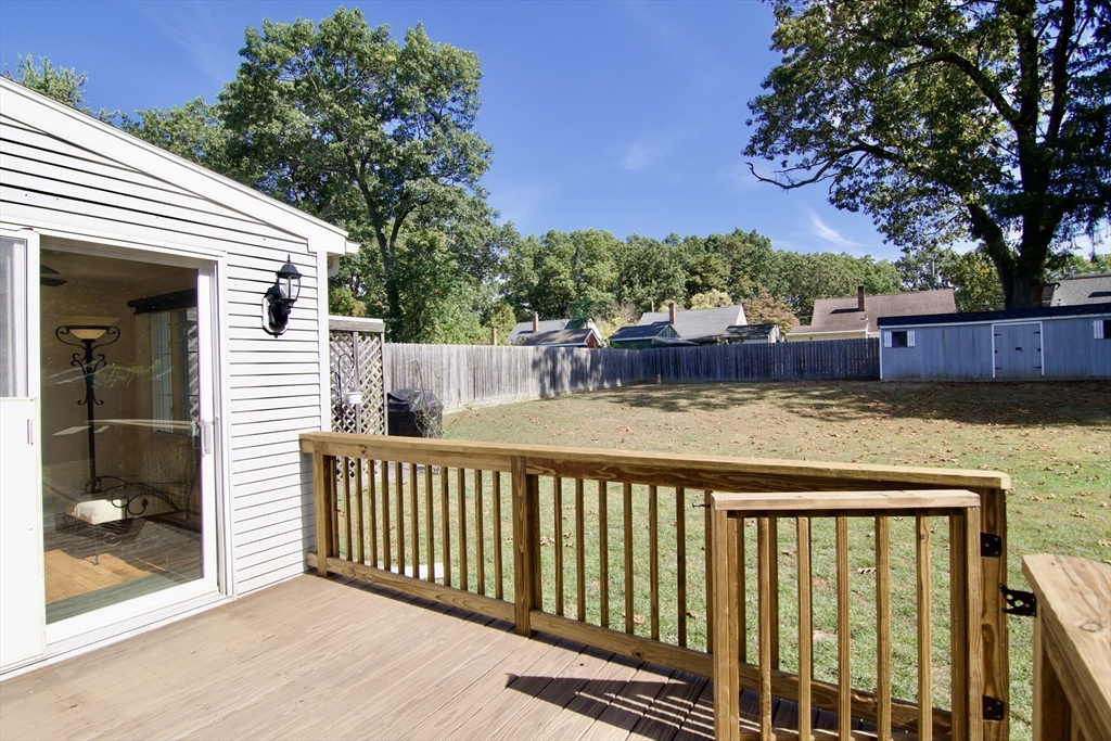 75 Wilton Street Springfield, MA 01109 - Photo 5 of 42 a view of a wooden deck and a backyard