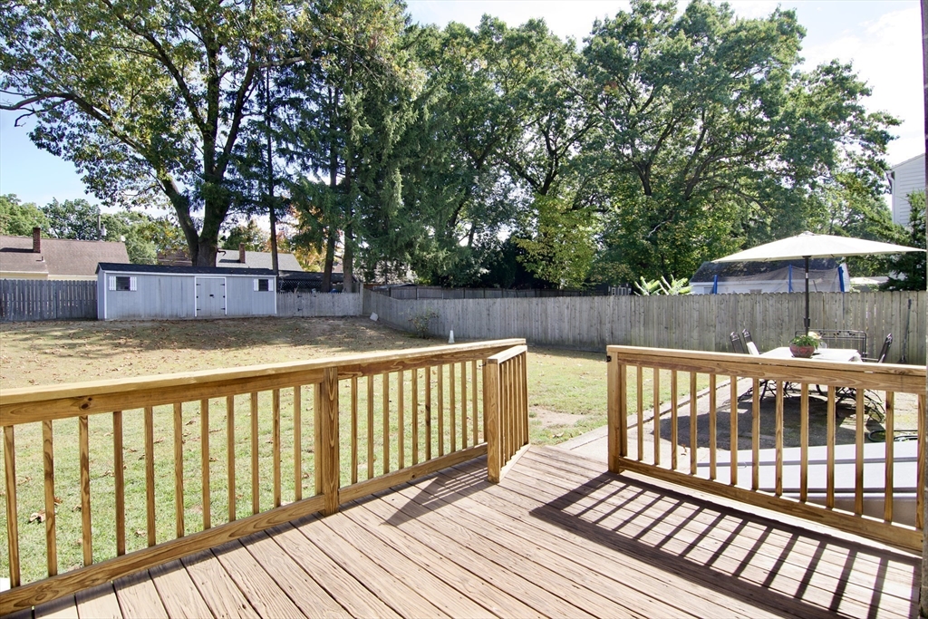 75 Wilton Street Springfield, MA 01109 - Photo 6 of 42 a view of a wooden deck with large trees