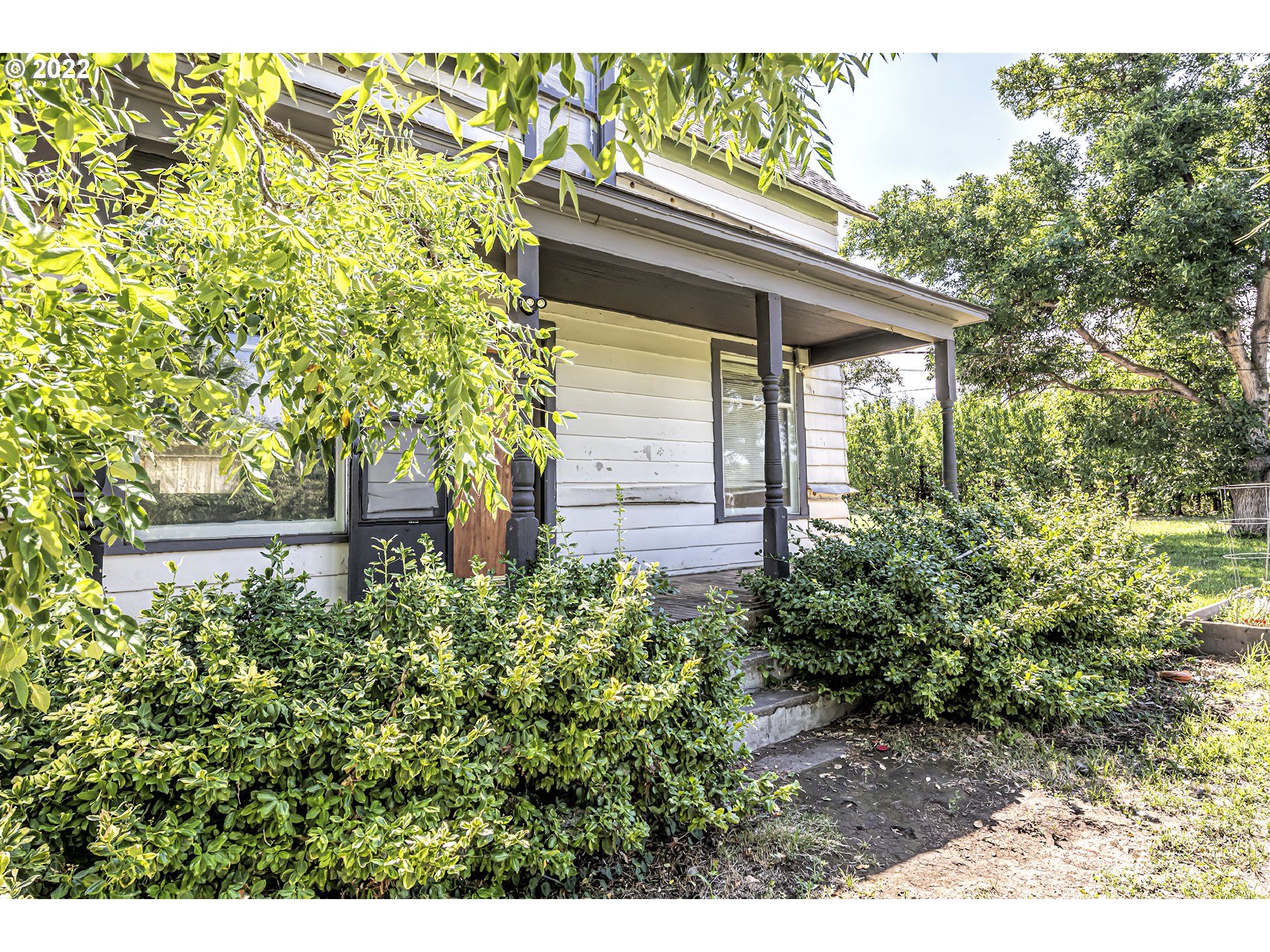 a view of house with backyard and garden