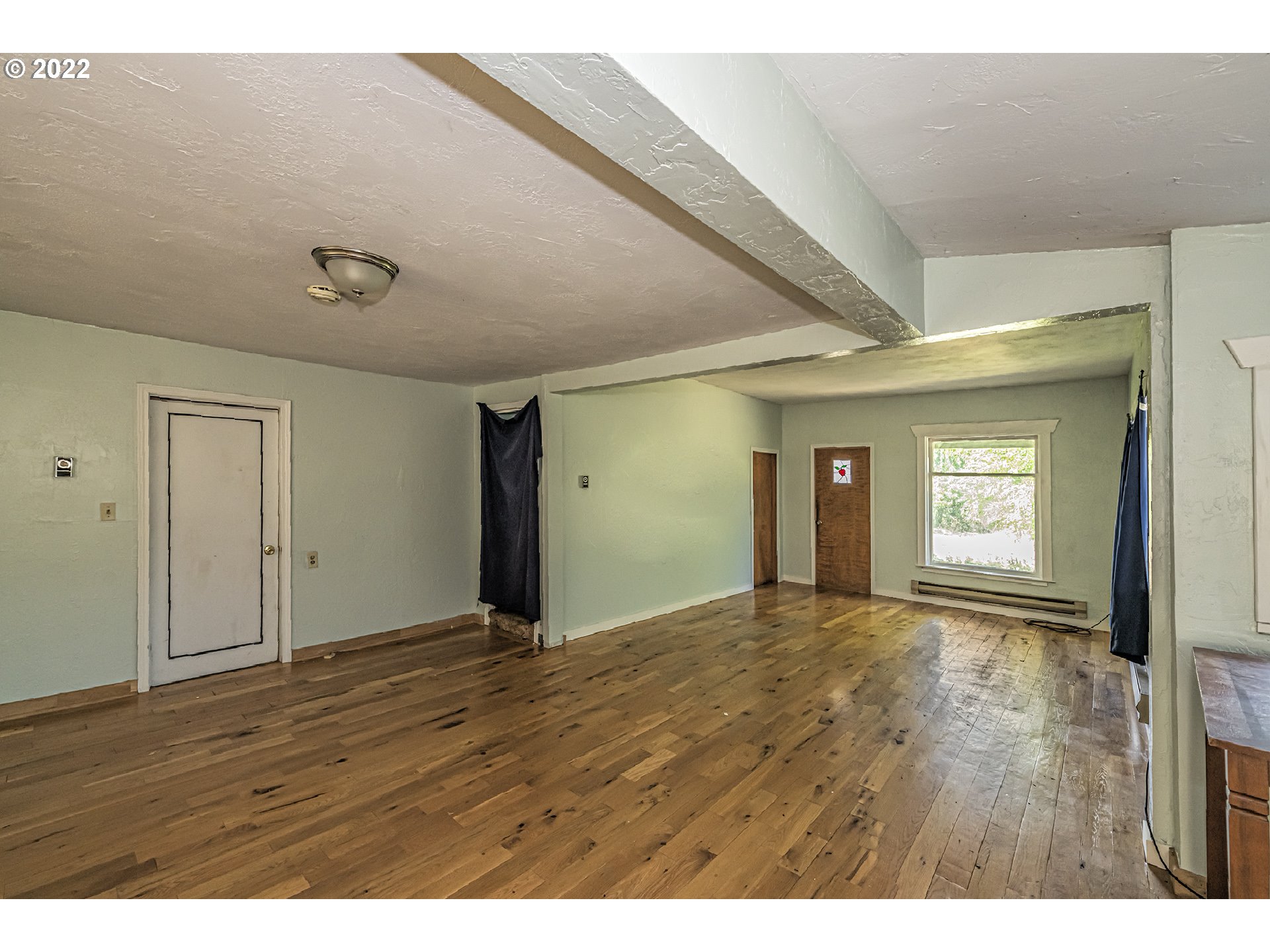 53486 Ruby Lane Milton Freewater, OR 97862 - Photo 4 of 27 a view of an empty room with wooden floor and a window