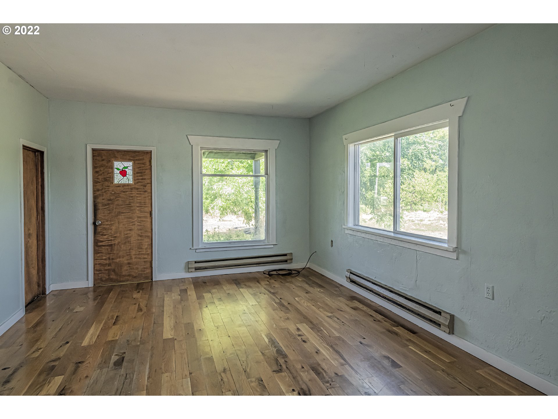 53486 Ruby Lane Milton Freewater, OR 97862 - Photo 9 of 27 a view of an empty room with wooden floor and a window