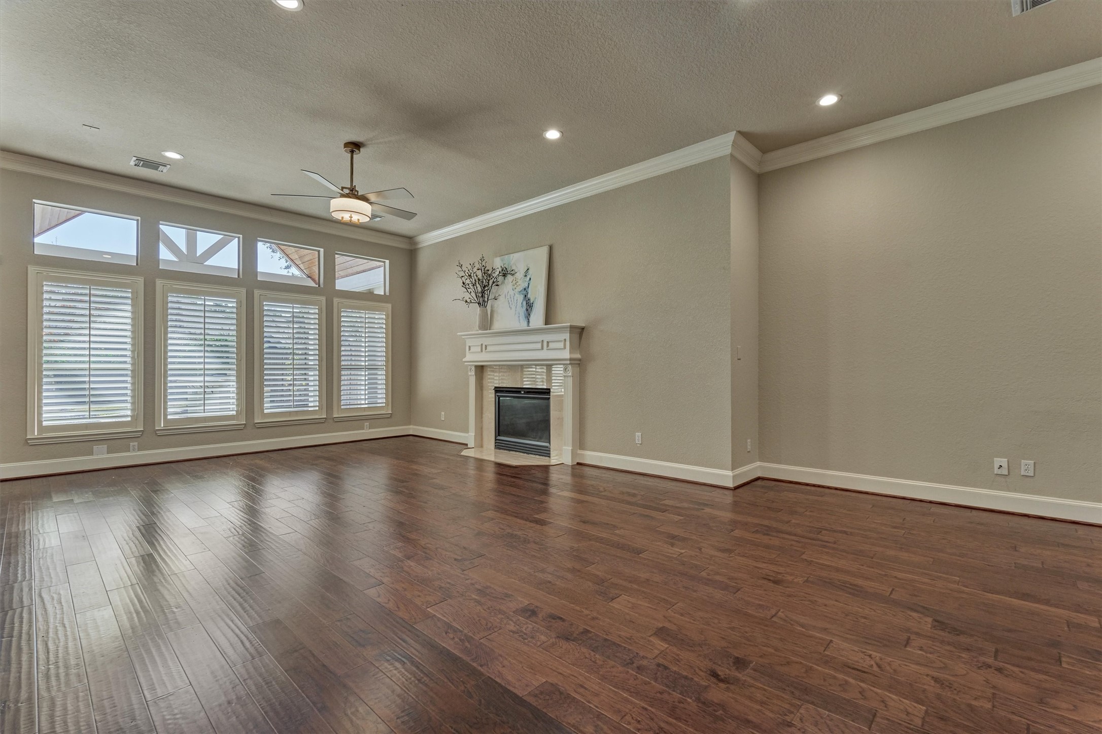 91 West Racing Cloud Court The Woodlands, TX 77381 - Photo 17 of 47 This vast great room is bathed in natural light with a cozy fireplace and mantle anchoring the room.