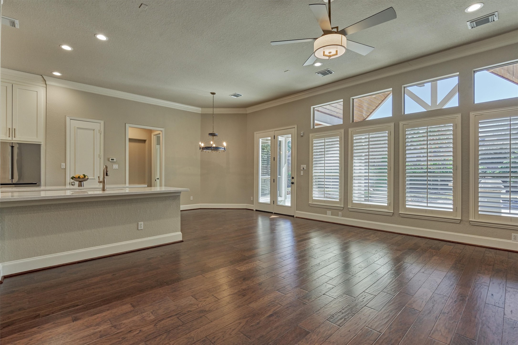 91 West Racing Cloud Court The Woodlands, TX 77381 - Photo 46 of 47 A wall of windows illuminates this great room, emphasizing the open concept floor plan. Note: breakfast bar sitting area.