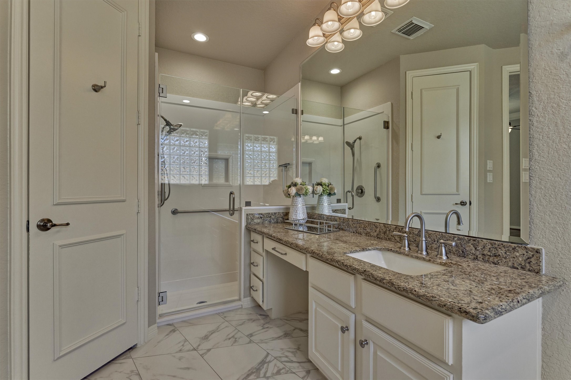 91 West Racing Cloud Court The Woodlands, TX 77381 - Photo 25 of 47 The primary bathroom has granite countertops and a large walk-in shower.