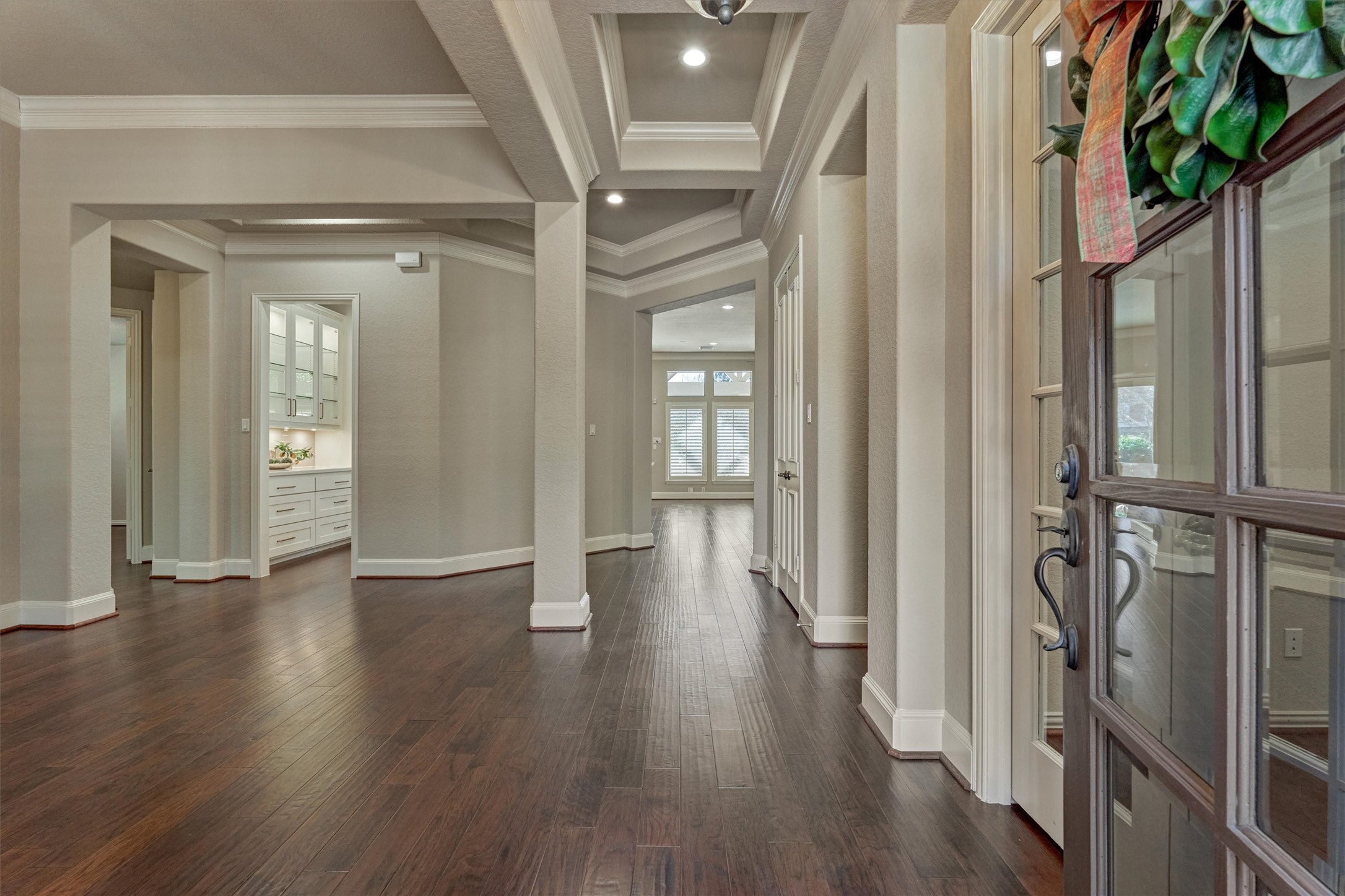 91 West Racing Cloud Court The Woodlands, TX 77381 - Photo 6 of 47 Step inside to an immaculate interior with continuous wood flooring throughout and soaring sight lines into the private backyard retreat.