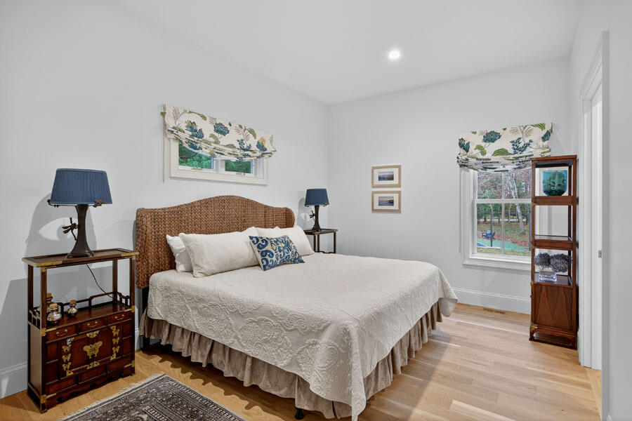280 Ice Valley Road Osterville, MA 02655 - Photo 28 of 45 a bedroom with a bed and wooden floor