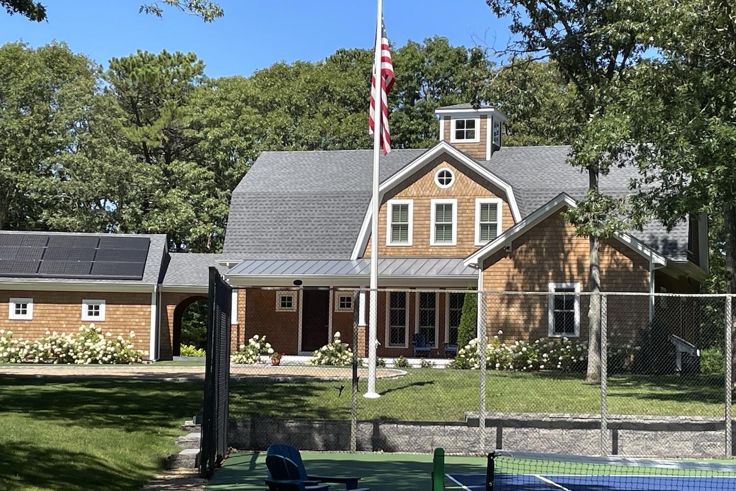 280 Ice Valley Road Osterville, MA 02655 - Photo 5 of 45 a front view of a house with a yard