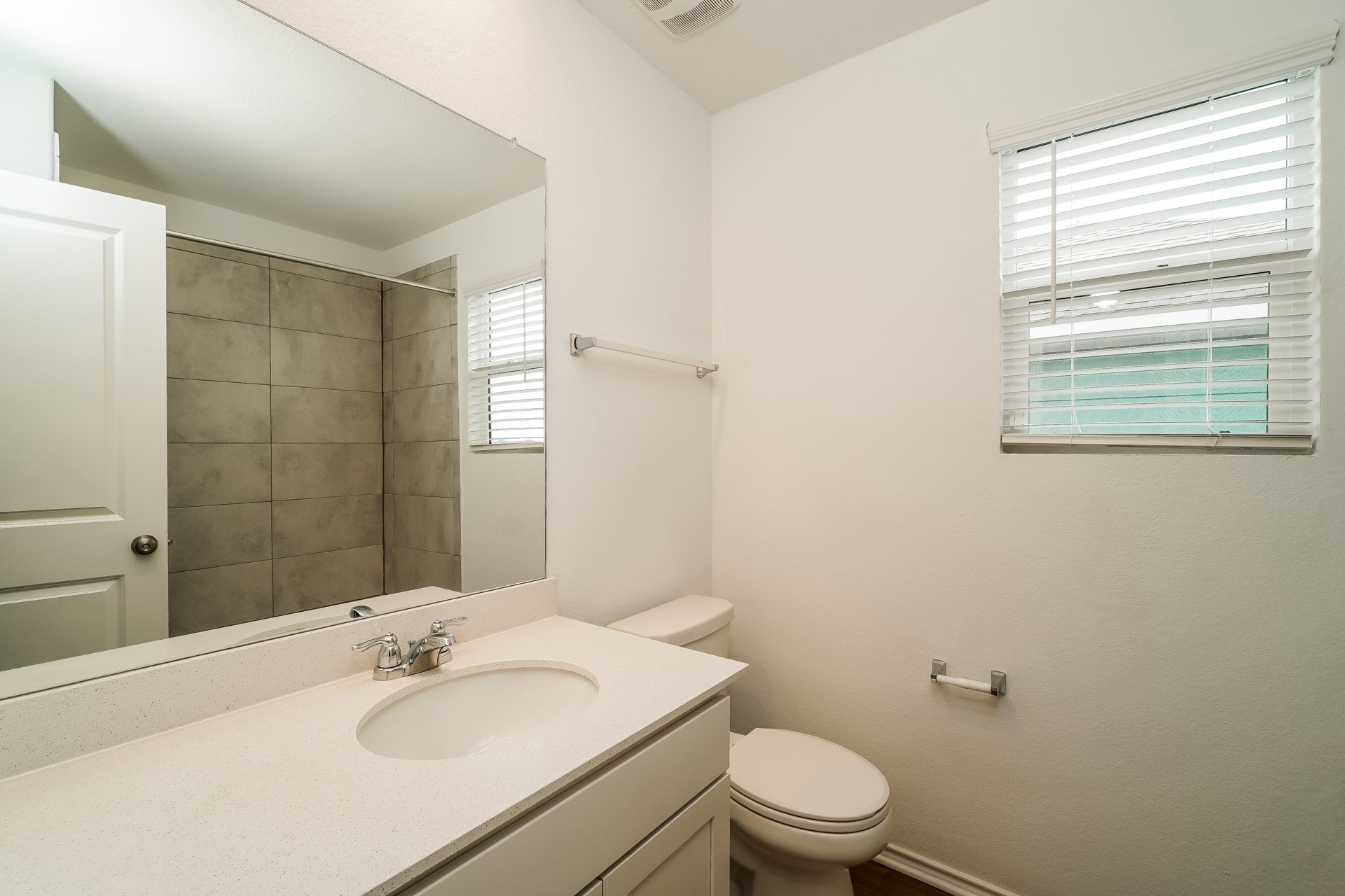 341 Madrid Kyle, TX 78640 - Photo 21 of 27 A well-appointed bathroom features a single vanity, a sleek toilet, and a tiled shower for daily comfort.