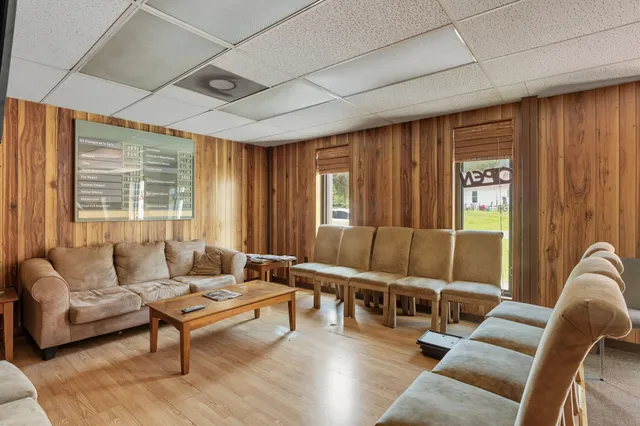 a living room with furniture and large window