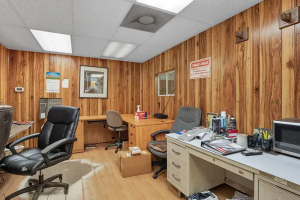 a view of a workspace with furniture and a window