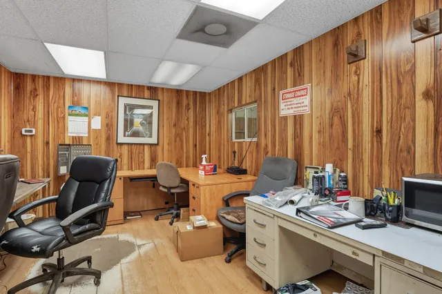 a view of a workspace with furniture and a window