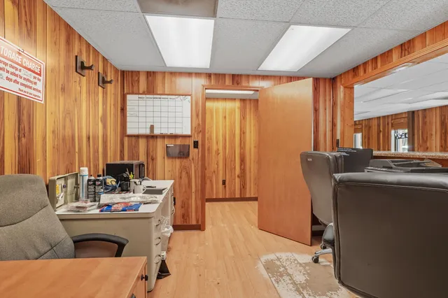 a view of a workspace with furniture and a window
