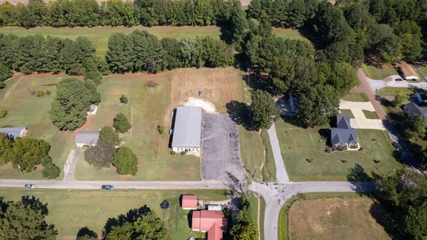 an aerial view of a house with a lake view