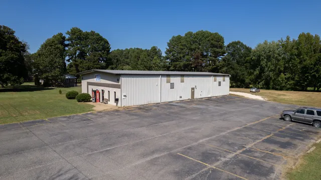 a view of a backyard with swimming pool and sitting area