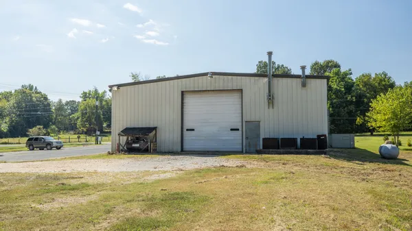 a view of a house with a yard and garage