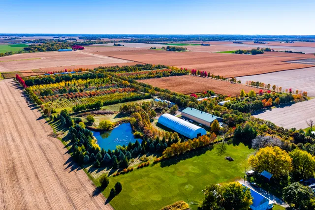 an aerial view of ocean and residential houses with outdoor space