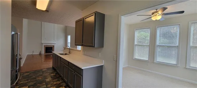 a kitchen with a sink refrigerator and microwave