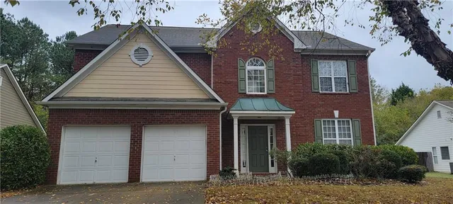 a front view of a house with garage