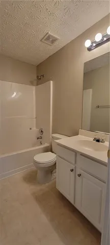 a bathroom with a double vanity sink toilet and a mirror