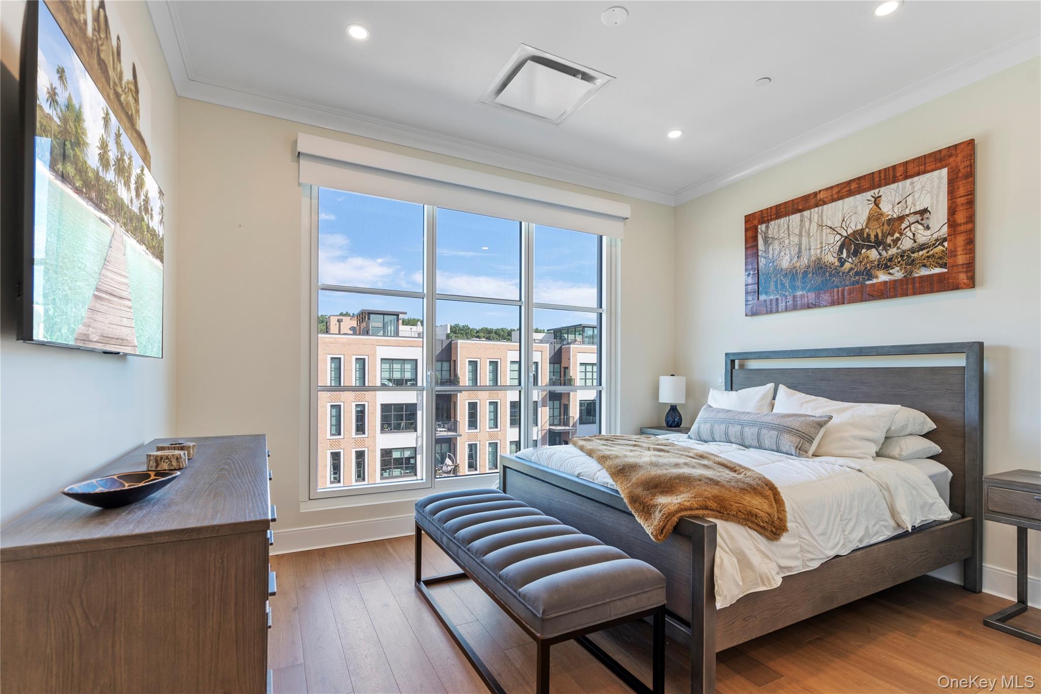 100 Garvies Point Road, Unit 1309 Glen Cove, NY 11542 - Photo 11 of 36 a bedroom with a large bed and a window