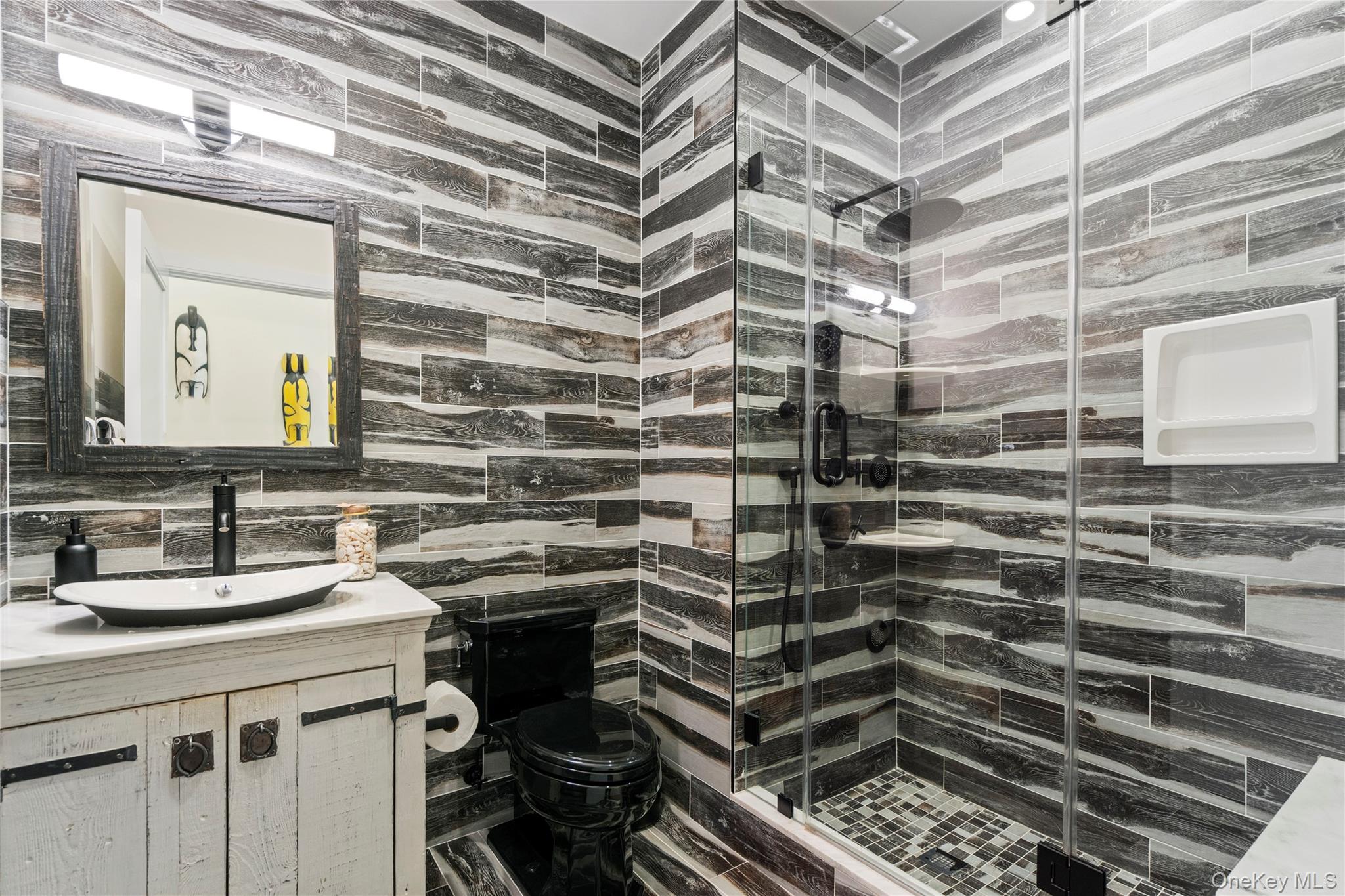 100 Garvies Point Road, Unit 1309 Glen Cove, NY 11542 - Photo 15 of 36 a bathroom with a sink and a mirror