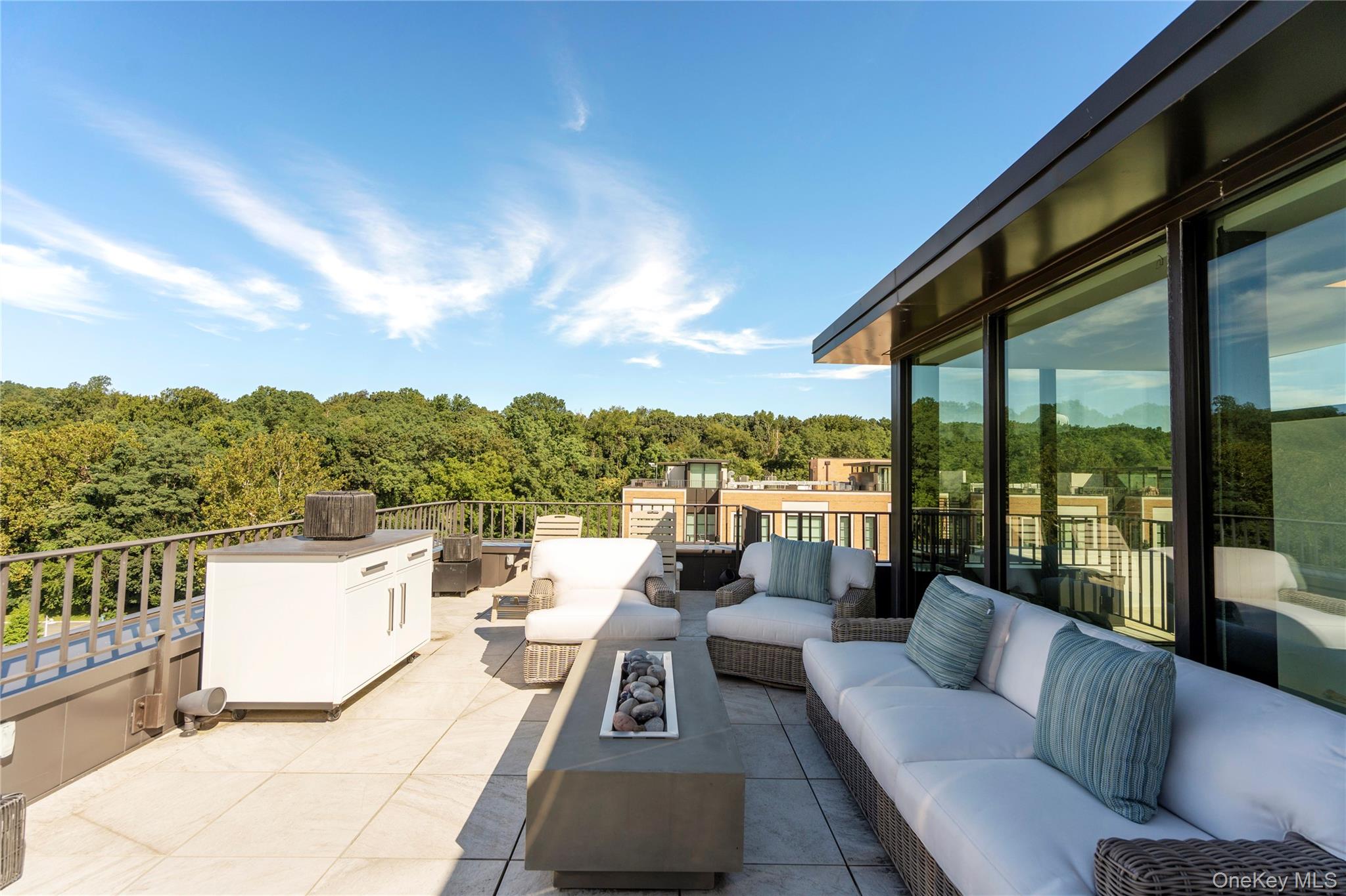 100 Garvies Point Road, Unit 1309 Glen Cove, NY 11542 - Photo 20 of 36 a view of a roof deck with couches and city view