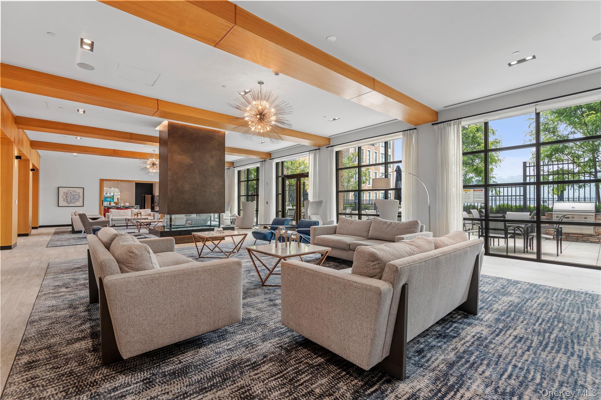 100 Garvies Point Road, Unit 1309 Glen Cove, NY 11542 - Photo 25 of 36 a living room with furniture and a large window