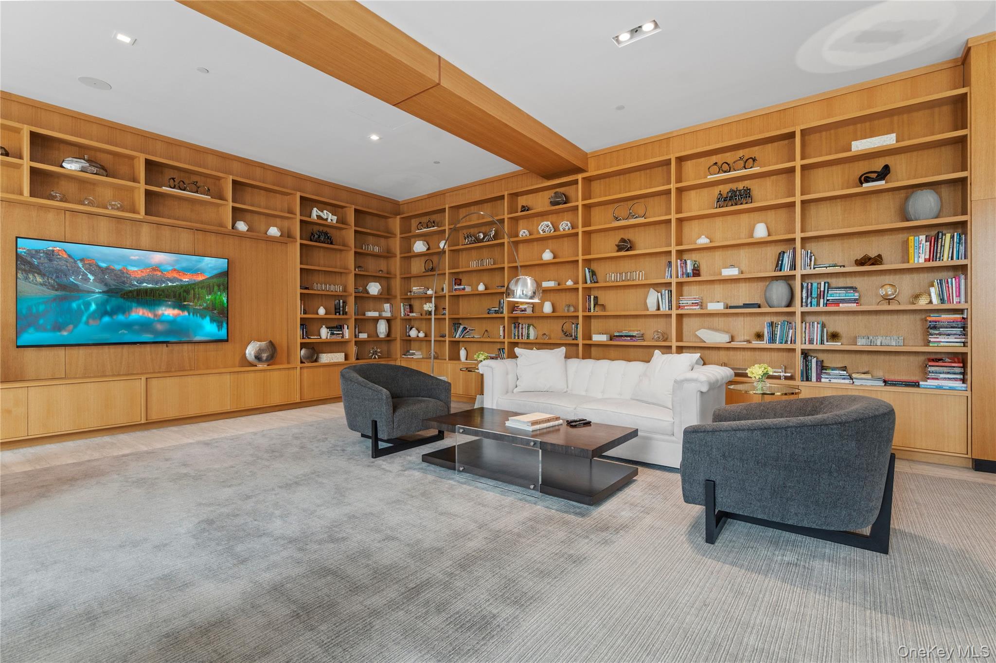 100 Garvies Point Road, Unit 1309 Glen Cove, NY 11542 - Photo 30 of 36 a living room with couch and a flat screen tv