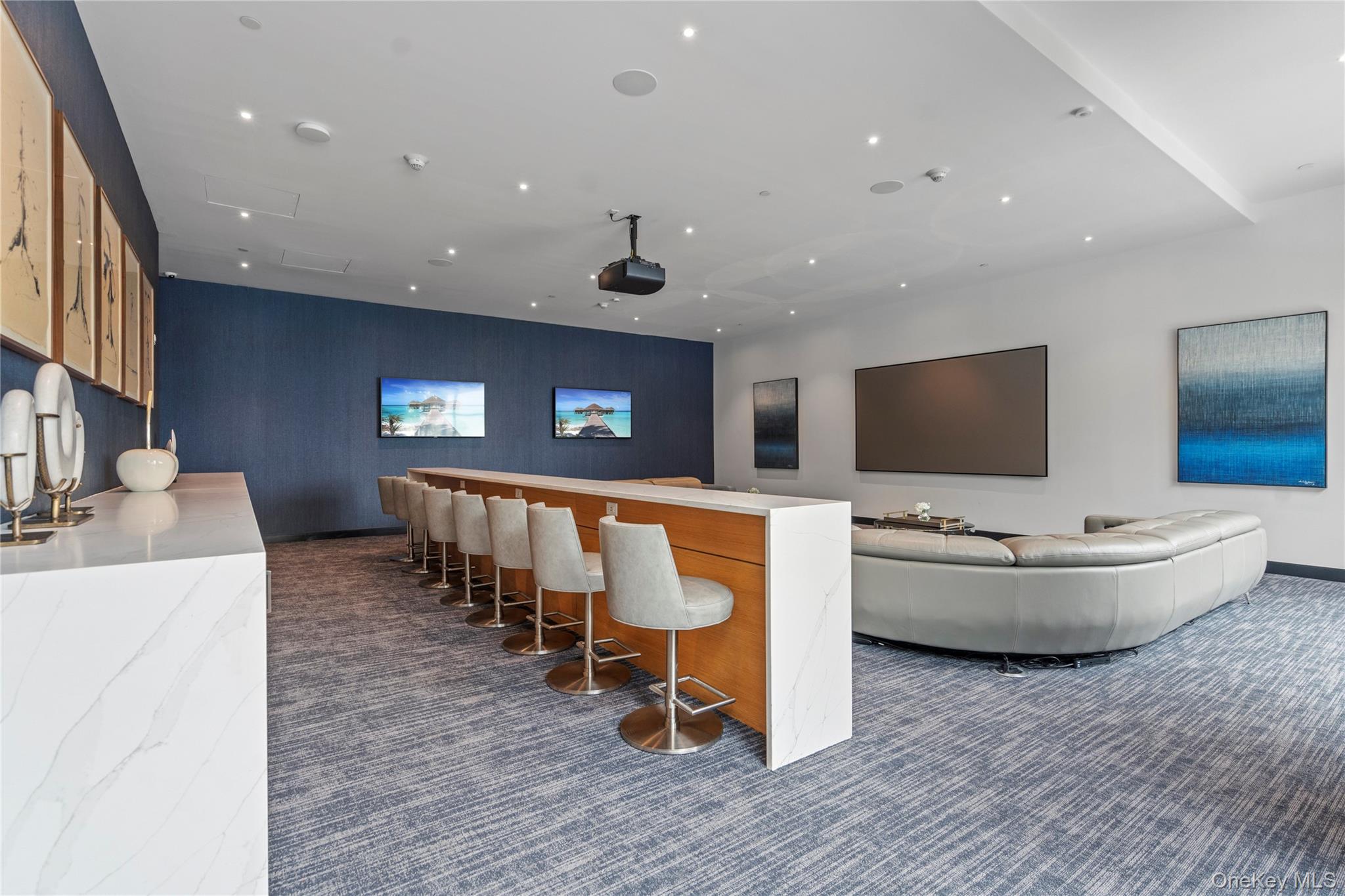 100 Garvies Point Road, Unit 1309 Glen Cove, NY 11542 - Photo 32 of 36 a living room with furniture and a flat screen tv