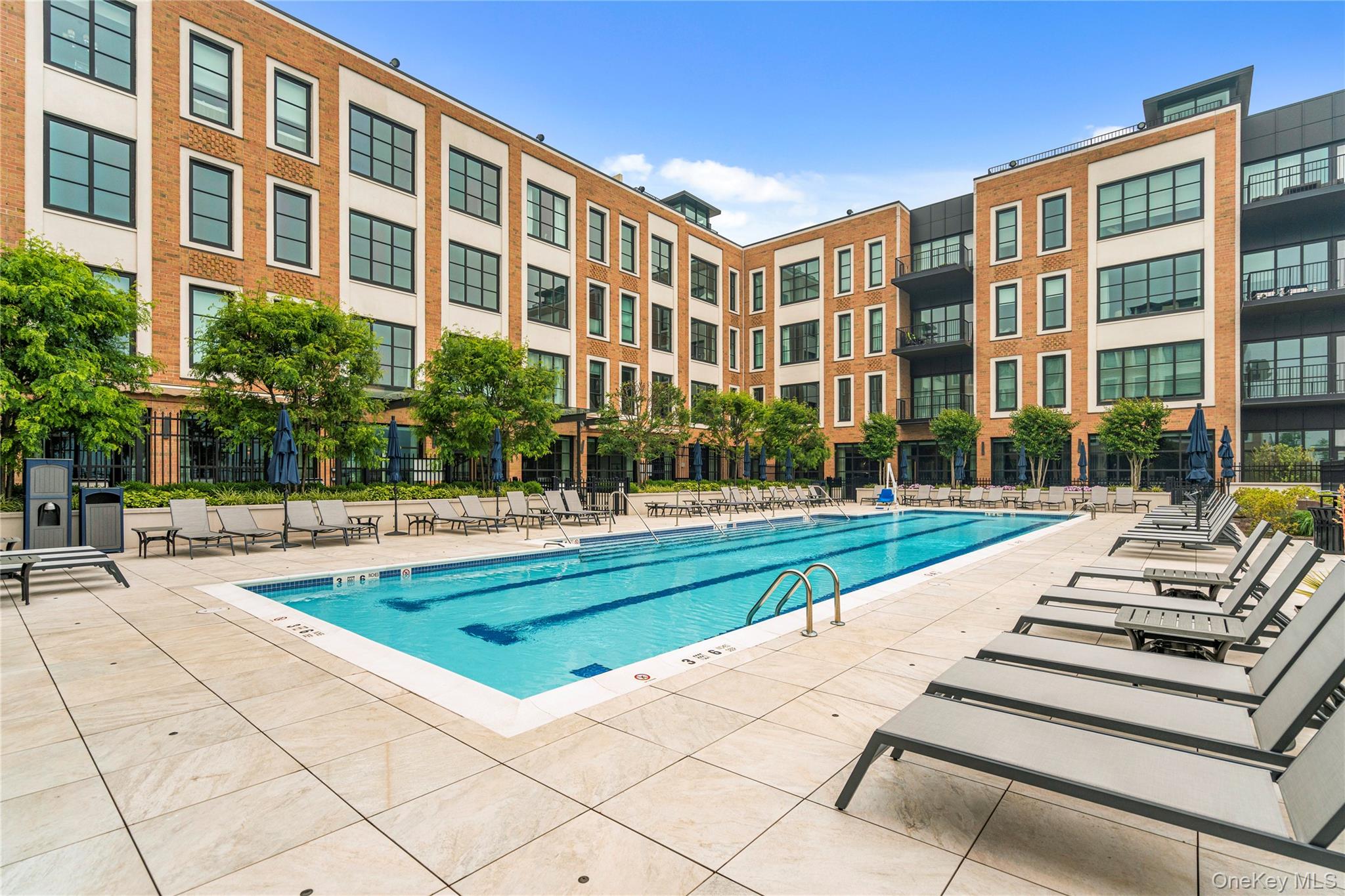 100 Garvies Point Road, Unit 1309 Glen Cove, NY 11542 - Photo 35 of 36 a view of a building with garden and swimming pool