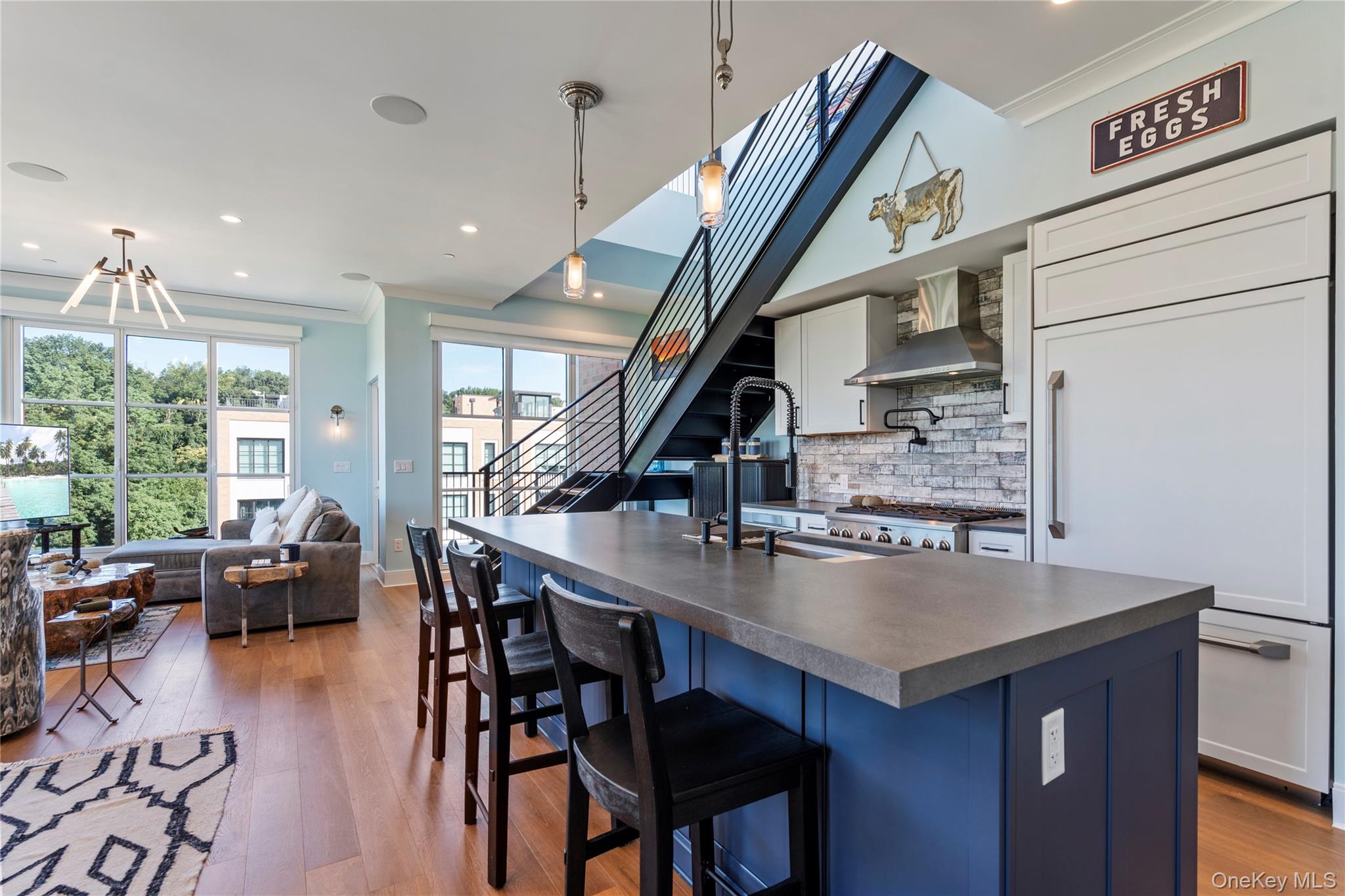 100 Garvies Point Road, Unit 1309 Glen Cove, NY 11542 - Photo 7 of 36 a living room with stainless steel appliances furniture a rug and a large window