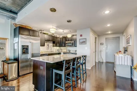 a large kitchen with a table and chairs