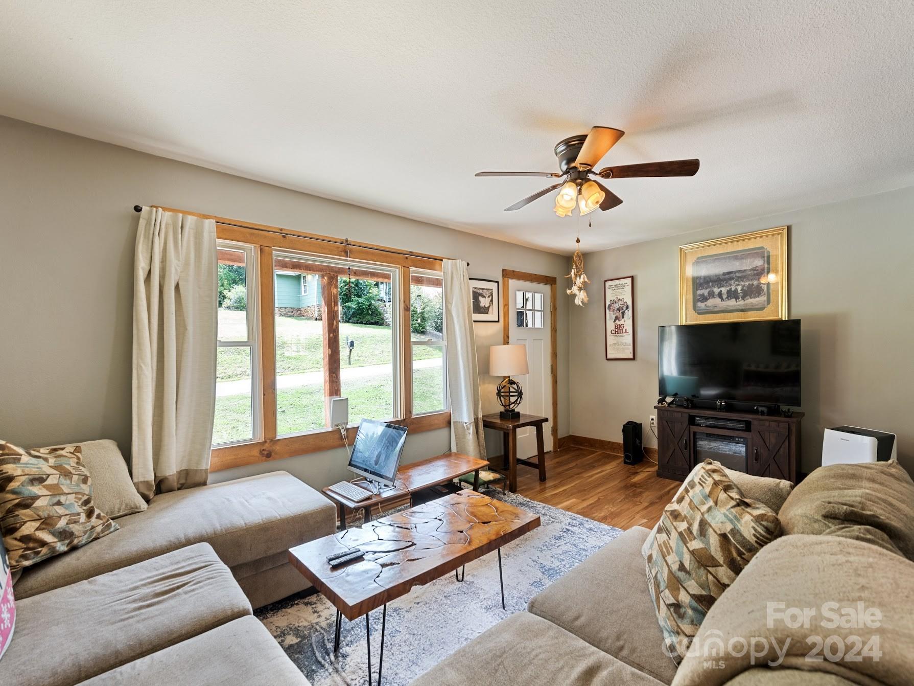 464 Thompson Cove Road Clyde, NC 28721 - Photo 14 of 36 a living room with furniture a flat screen tv and a large window