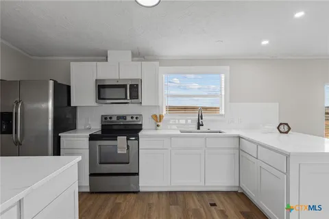 a kitchen with a sink stove and refrigerator