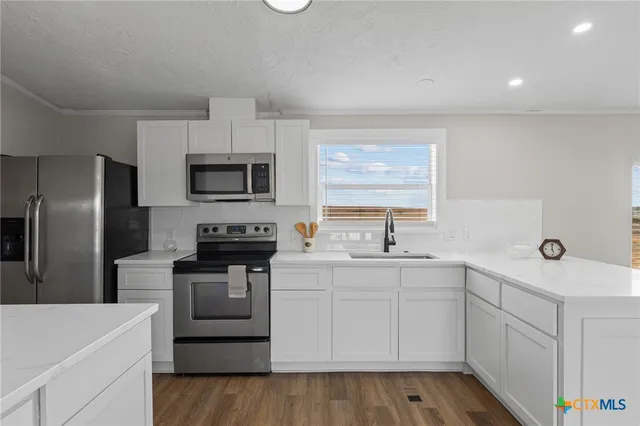 a kitchen with a sink stove and refrigerator