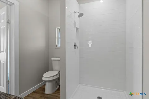 a bathroom with a toilet and a shower