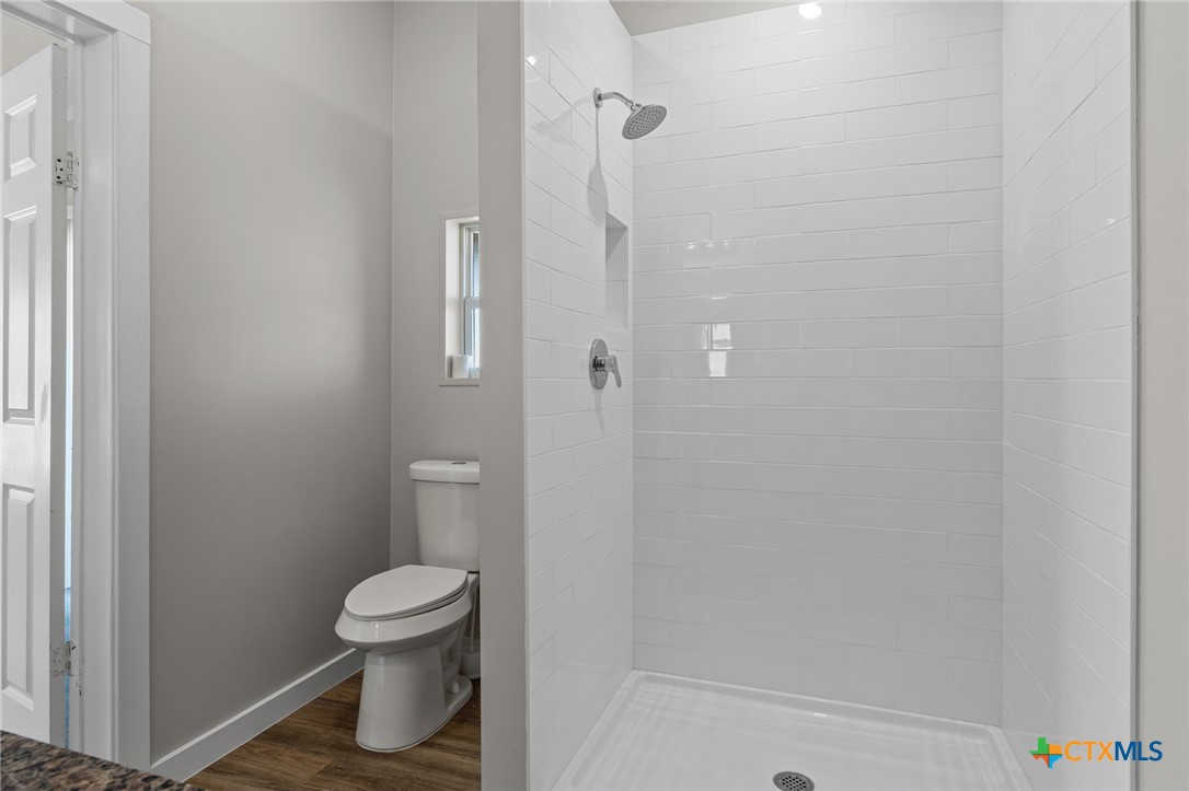 183 Altamira Avenue Elgin, TX 78621 - Photo 20 of 37 a bathroom with a toilet and a shower