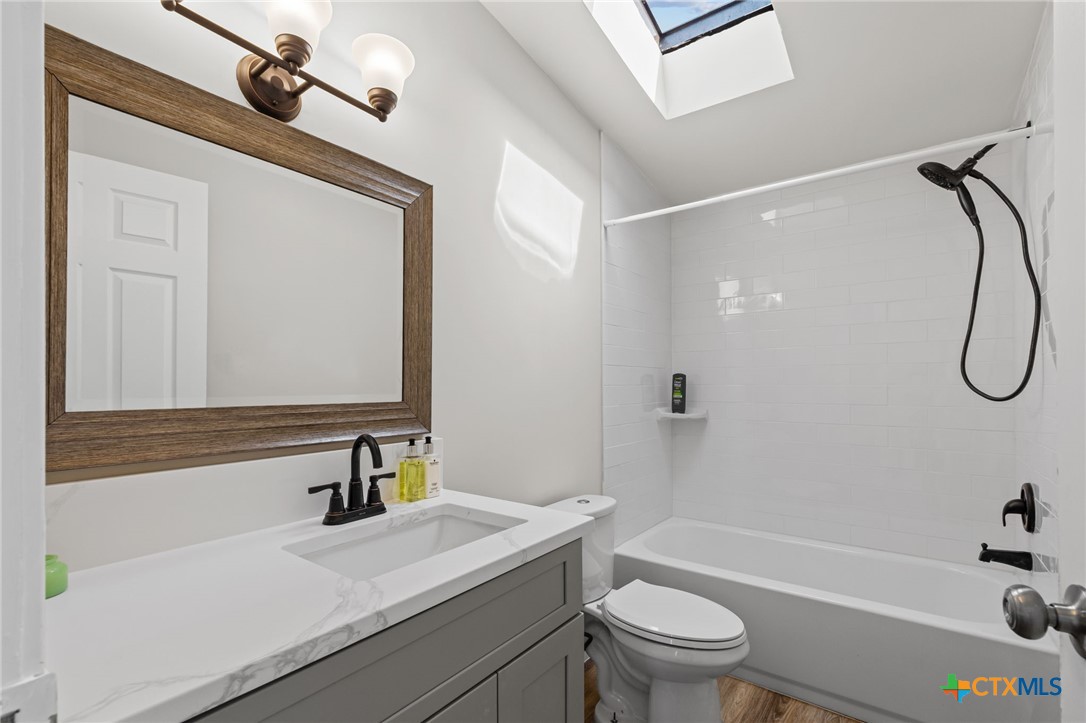 183 Altamira Avenue Elgin, TX 78621 - Photo 25 of 37 a bathroom with a sink a toilet and shower