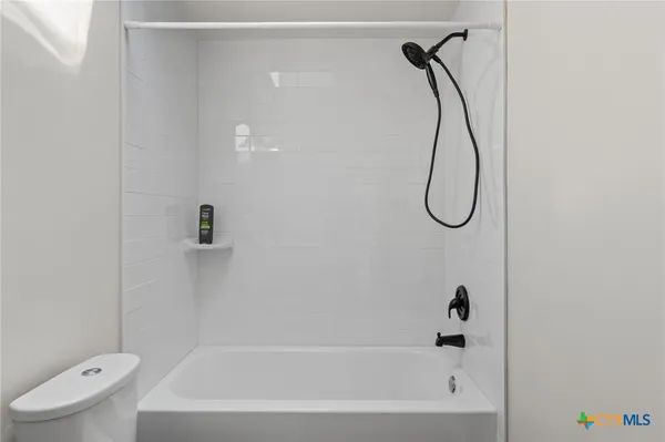 a bathroom with a bath tub with a shower