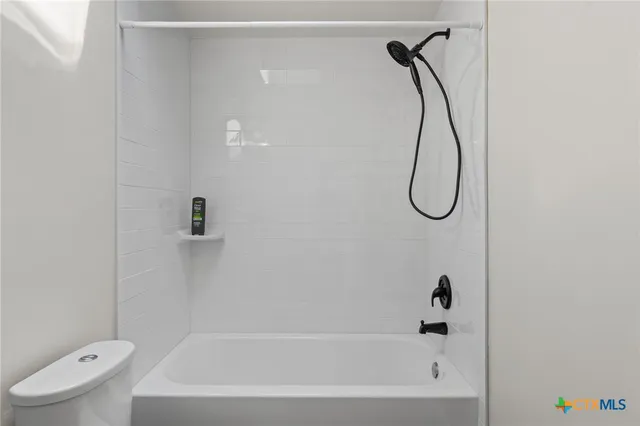 a bathroom with a bath tub with a shower