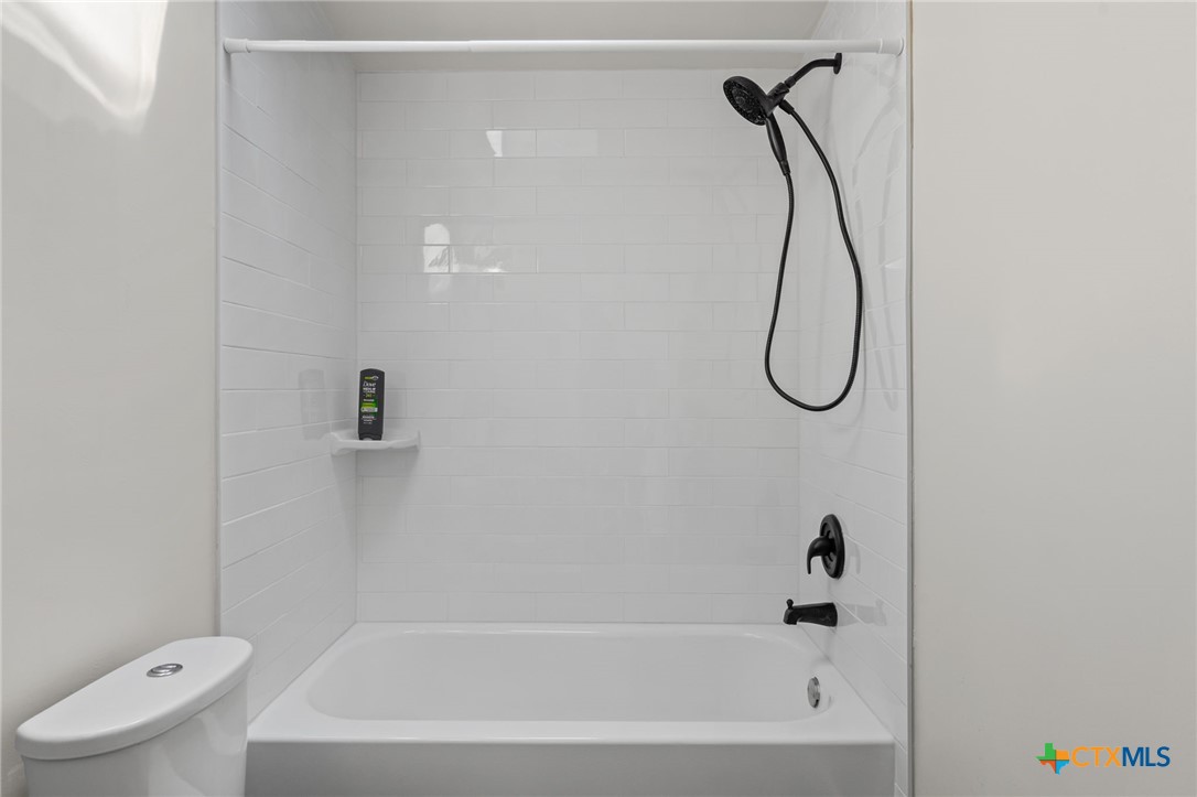 183 Altamira Avenue Elgin, TX 78621 - Photo 26 of 37 a bathroom with a bath tub with a shower
