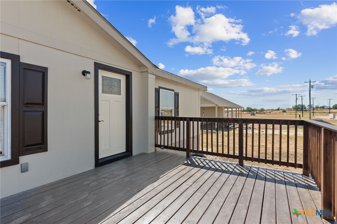 183 Altamira Avenue Elgin, TX 78621 - Photo 6 of 37 a view of a balcony with wooden floor