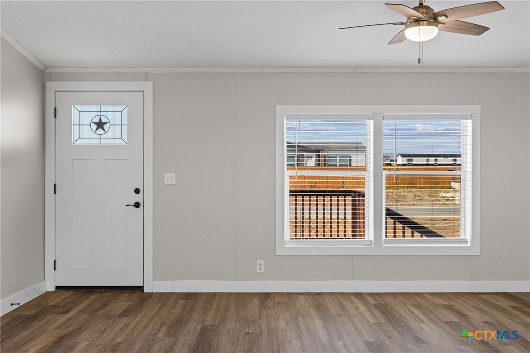 183 Altamira Avenue Elgin, TX 78621 - Photo 8 of 37 a view of an empty room with wooden floor and a window
