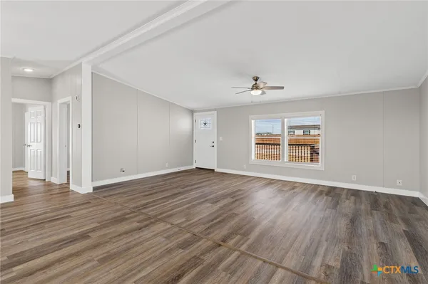 wooden floor in an empty room with a window