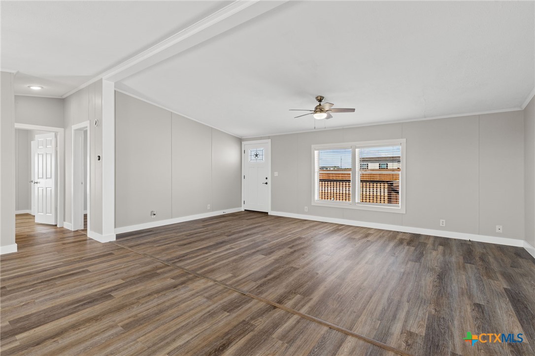 183 Altamira Avenue Elgin, TX 78621 - Photo 9 of 37 wooden floor in an empty room with a window