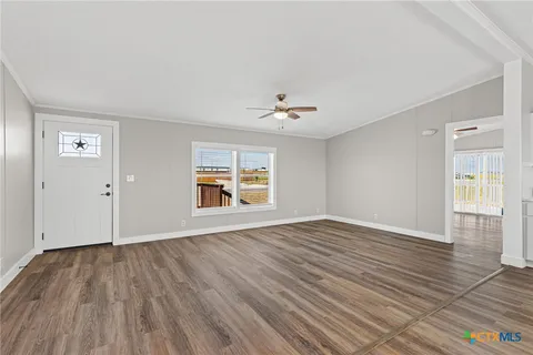 wooden floor in an empty room with a window