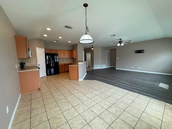 a kitchen with stainless steel appliances granite countertop a refrigerator and a stove top oven
