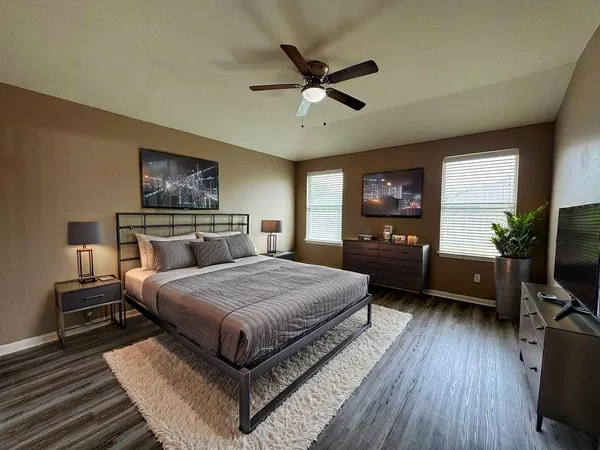 a bathroom with a tub sink and mirror