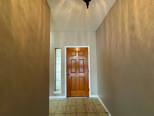 a view of a hallway with wooden shelves